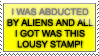 A yellow stamp that reads: I was abducted by aliens and all I got was this lousy stamp.
