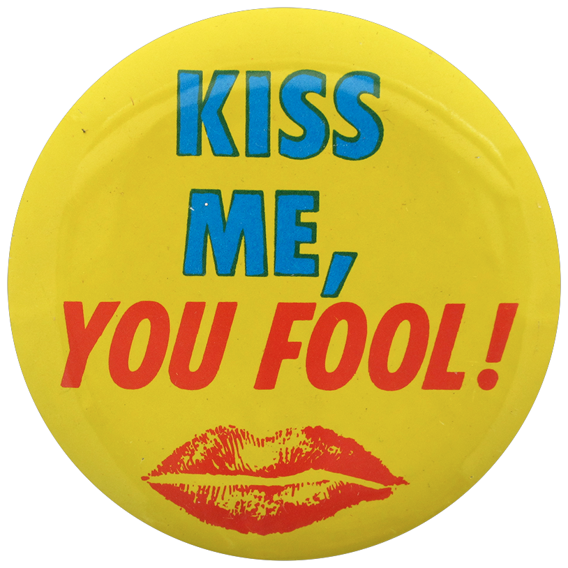 A yellow pinback button with red lips on it reading: Kiss me, you fool.