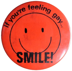 A red pinback button with a black smiley face reading: If you're feeling gay, smile!